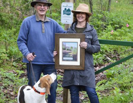 Pete and Ginny Quirin with a commemorative photo from their easement closing